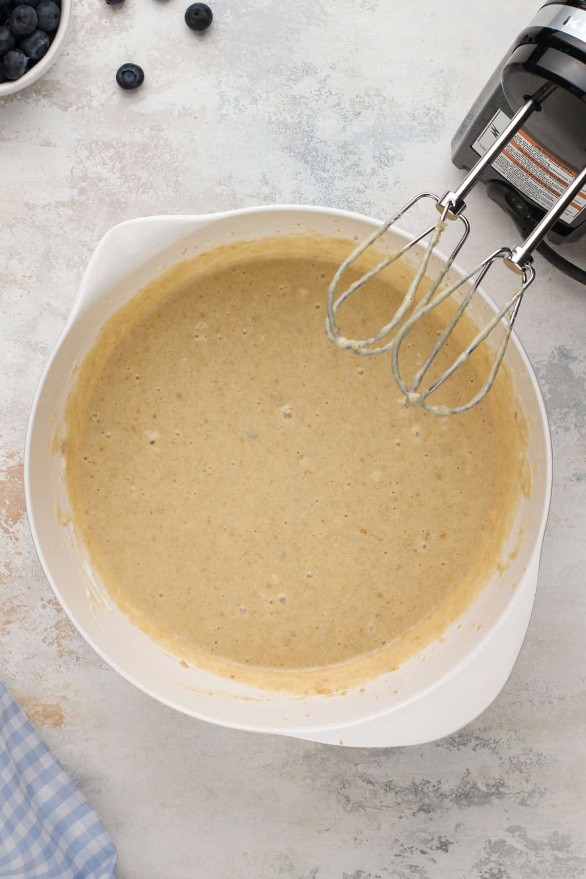 Wet ingredients for blueberry banana bread mixed in a bowl.