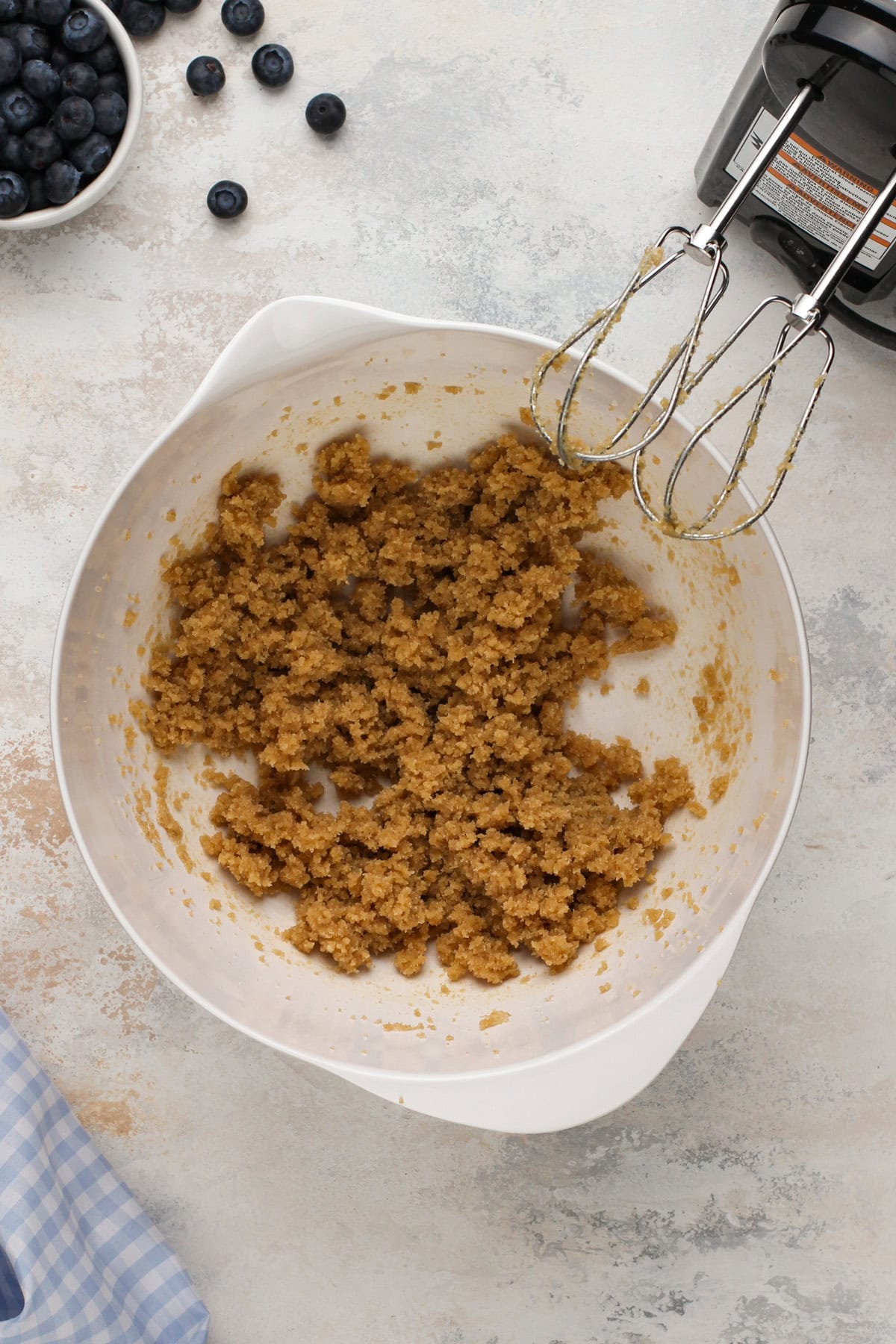 Brown sugar and butter creamed in a mixing bowl.