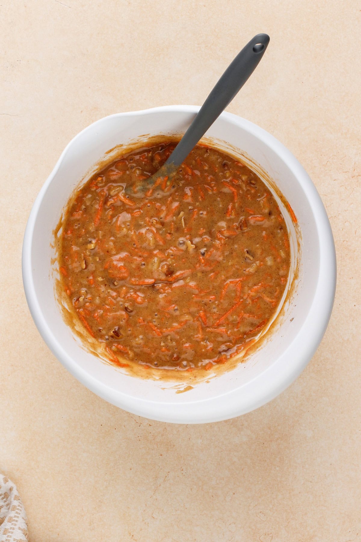 Carrot cake bar batter mixed in a white bowl.