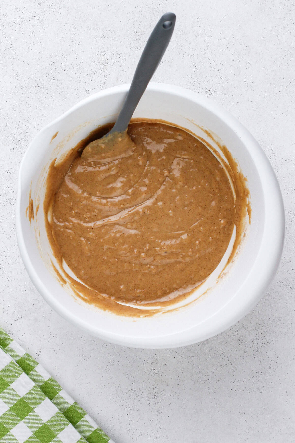 Batter base for carrot cake bread mixed in a white bowl.