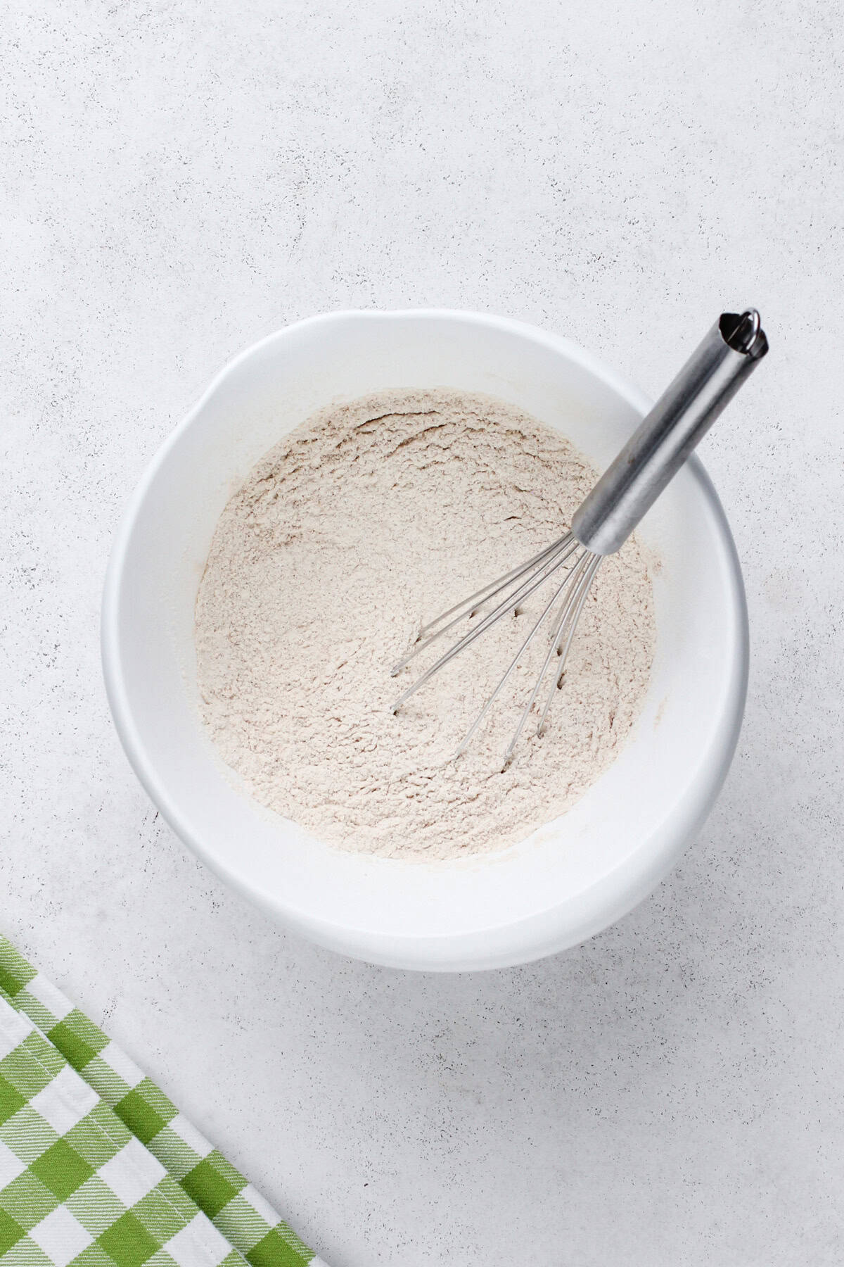 Carrot cake bread dry ingredients whisked in a mixing bowl.