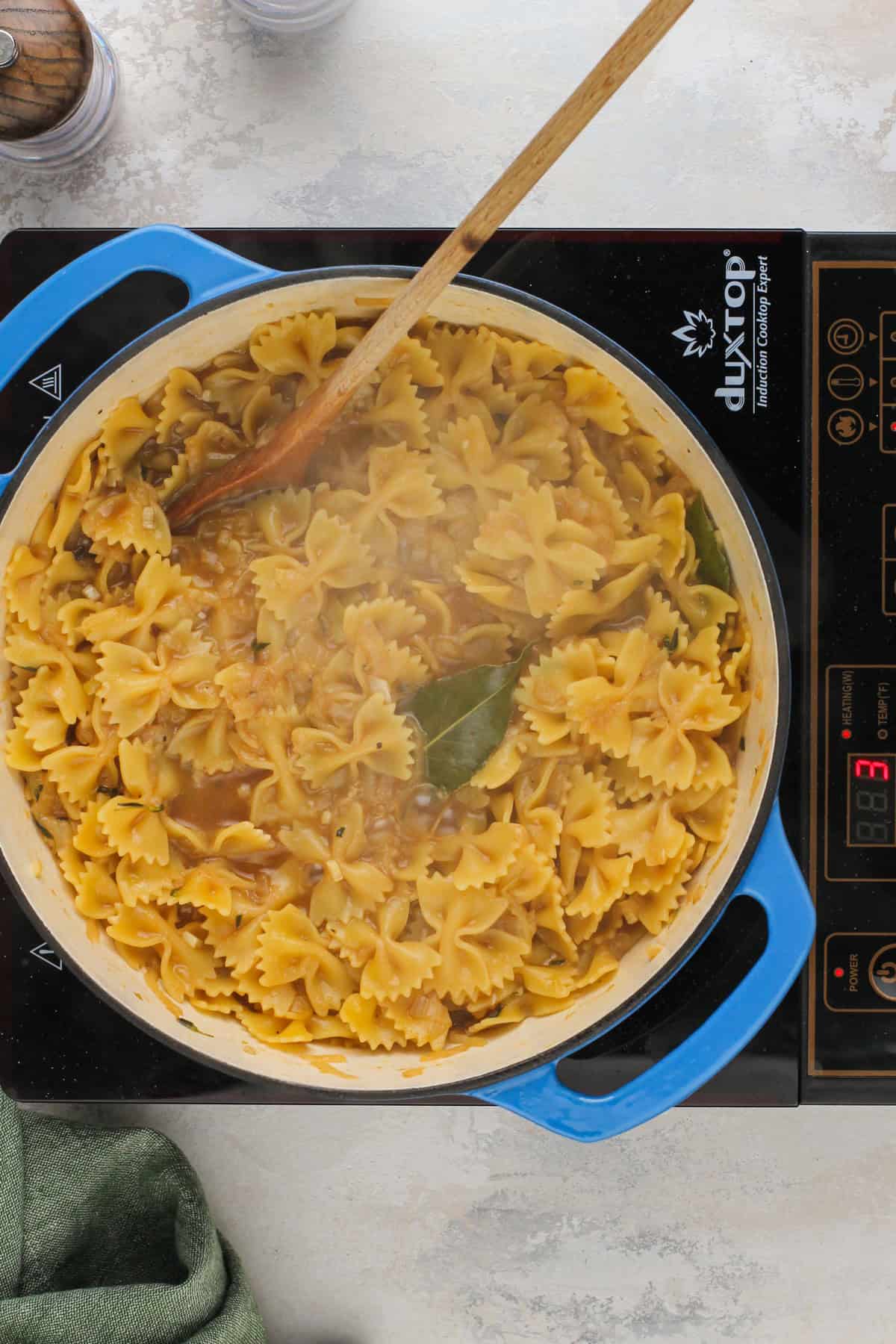 Cooked french onion pasta, ready for cheese and cream.