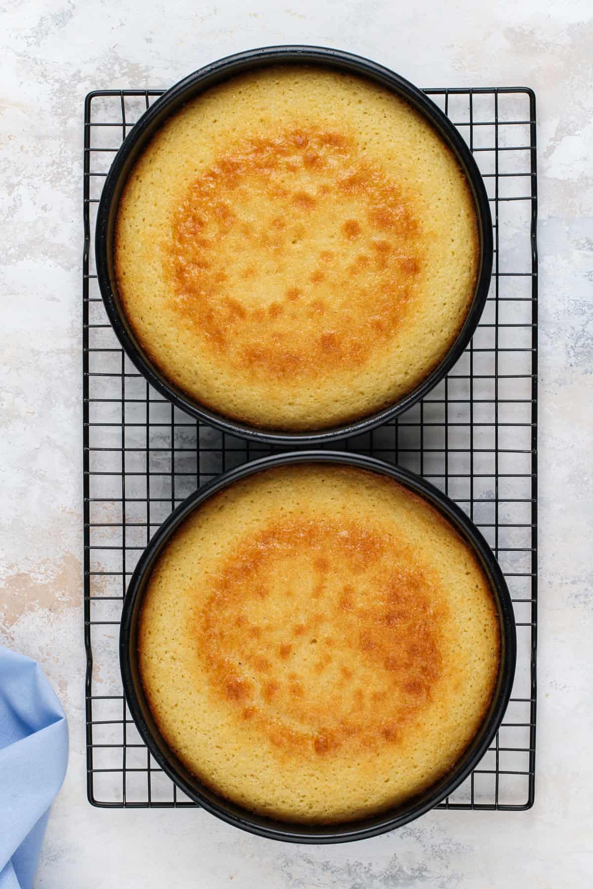 Cooling vanilla cake layers on a wire rack.