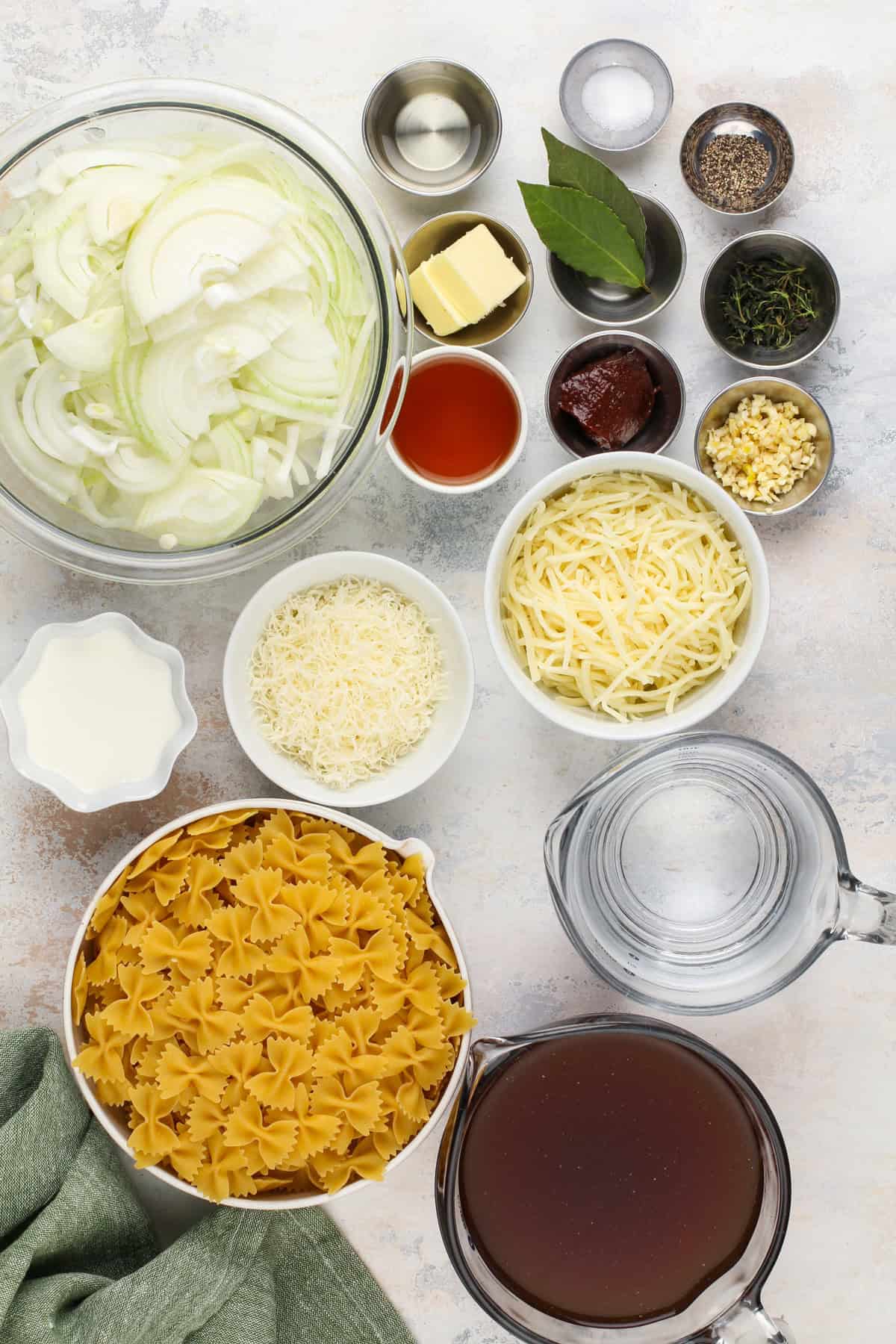 French onion pasta ingredients arranged on a countertop.