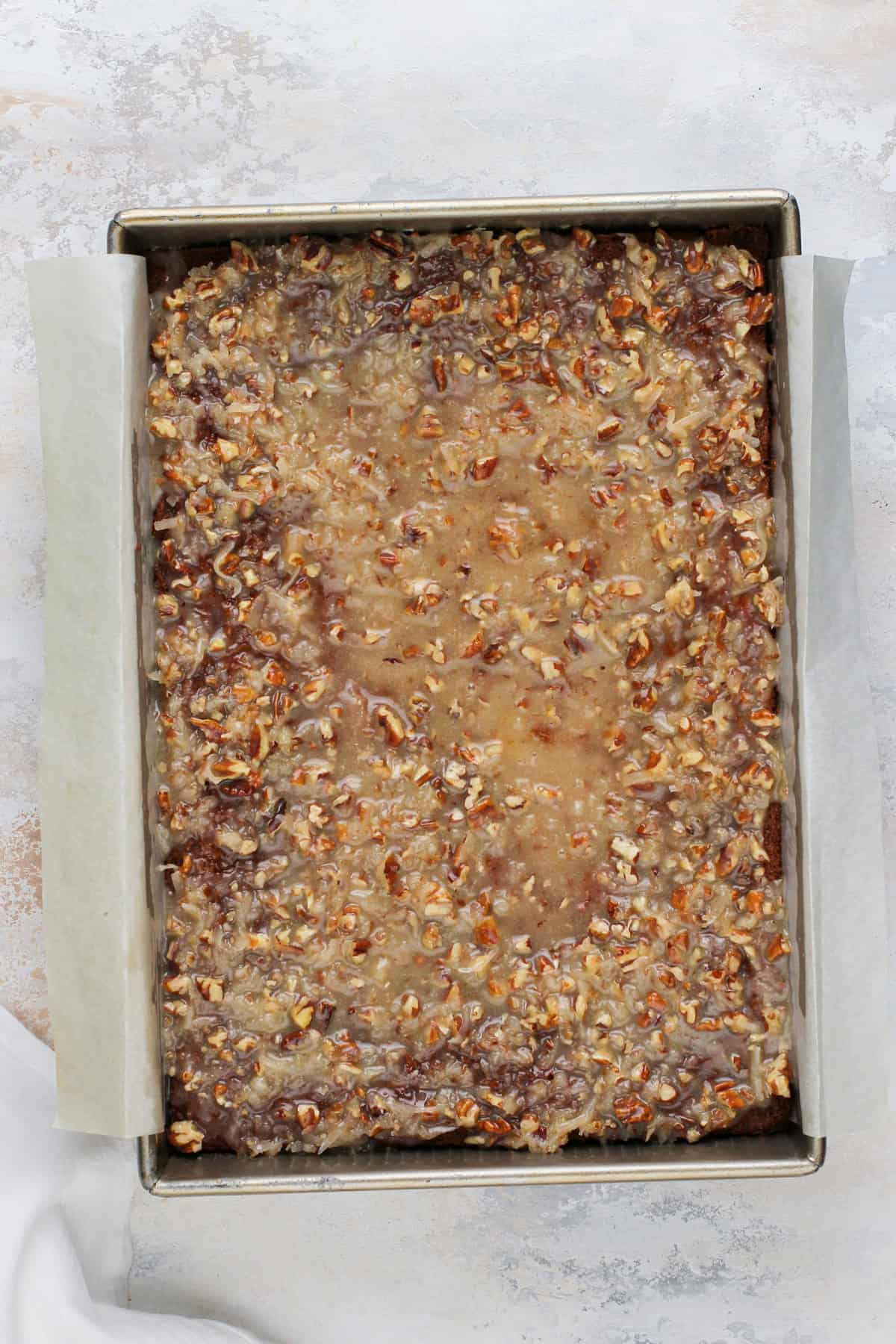 Fruit cocktail cake topped with pecan and coconut frosting.