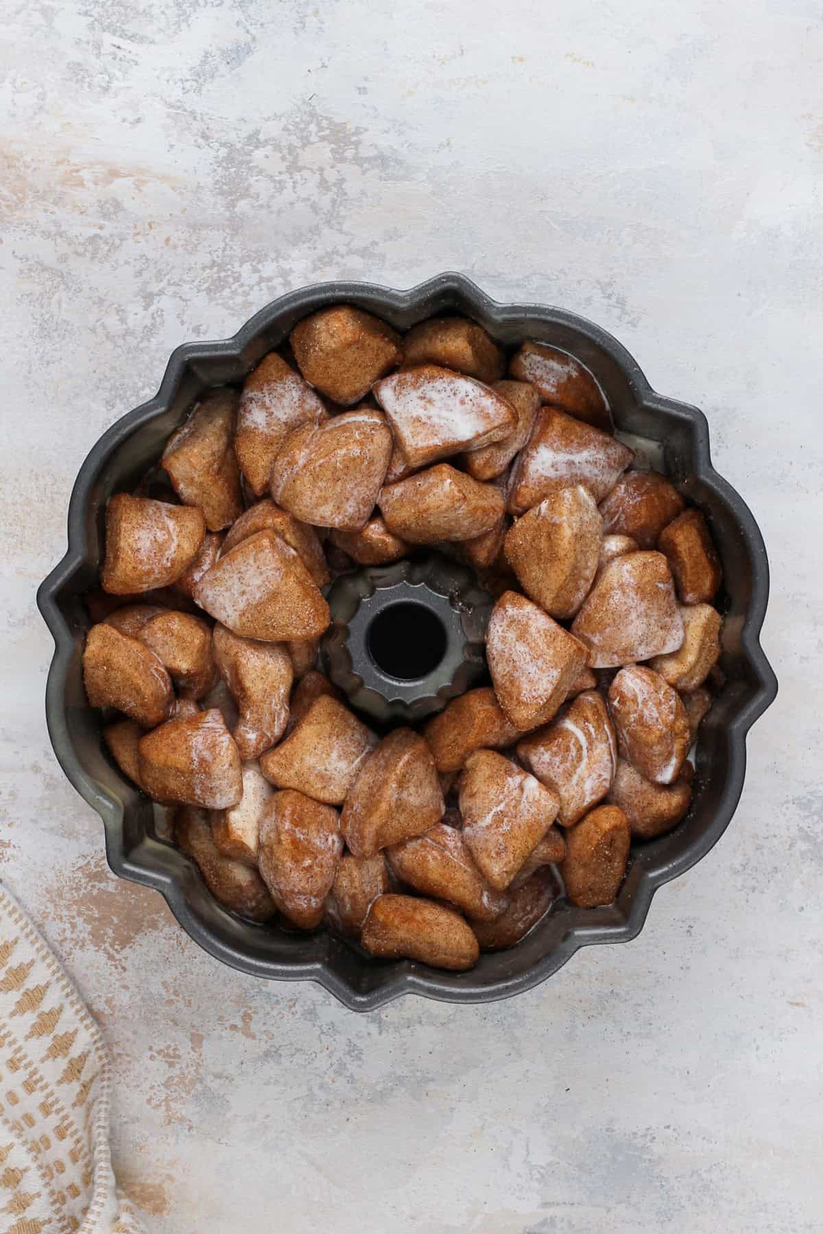 Biscuit pieces arranged in a bundt pan and topped with heavy cream.