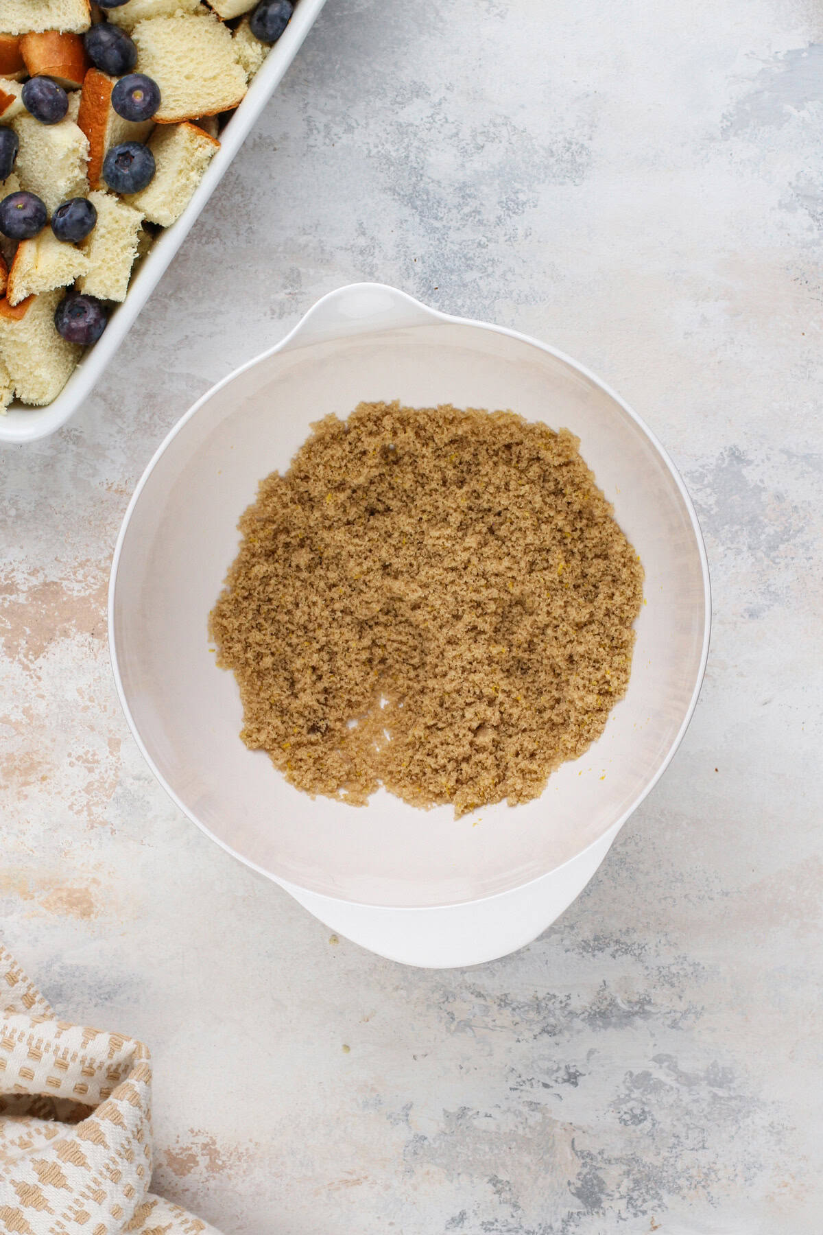 Brown sugar and lemon zest mixed together in a white bowl.