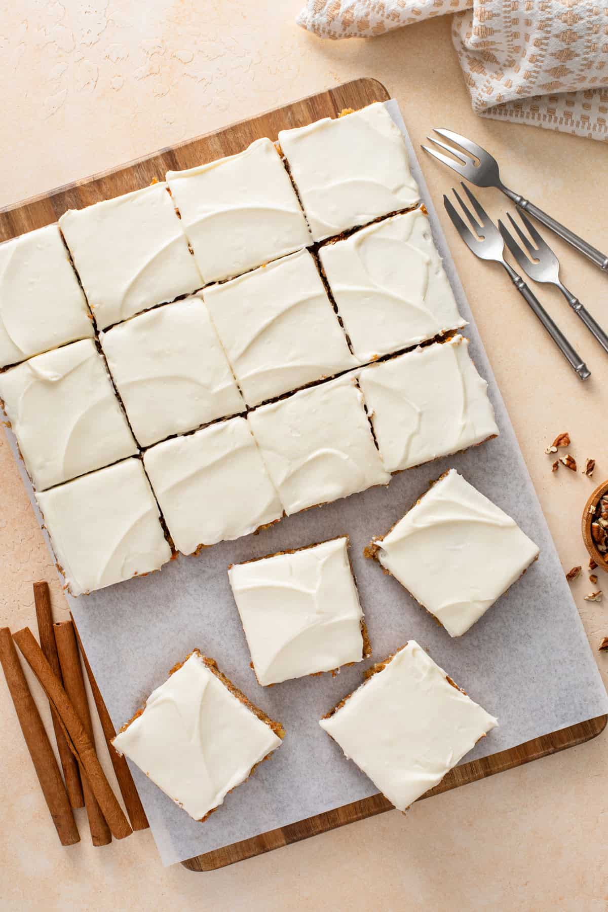 Overhead view of sliced carrot cake bars topped with cream cheese frosting.
