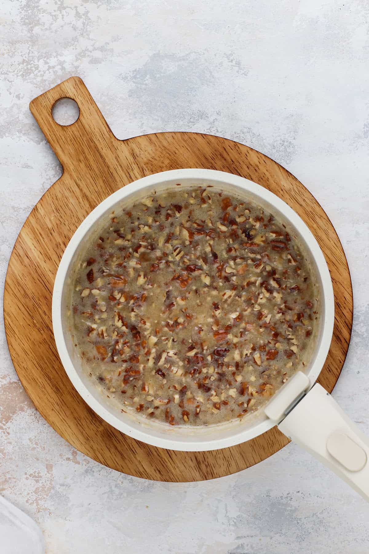 Pecan and coconut frosting for fruit cocktail cake cooked in a saucepan.