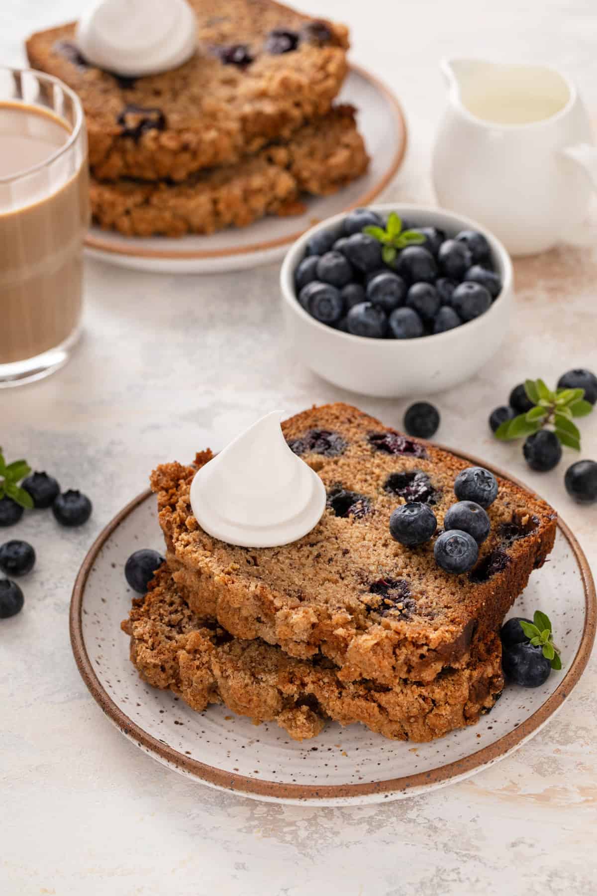 Two slices of blueberry banana bread on a plate.