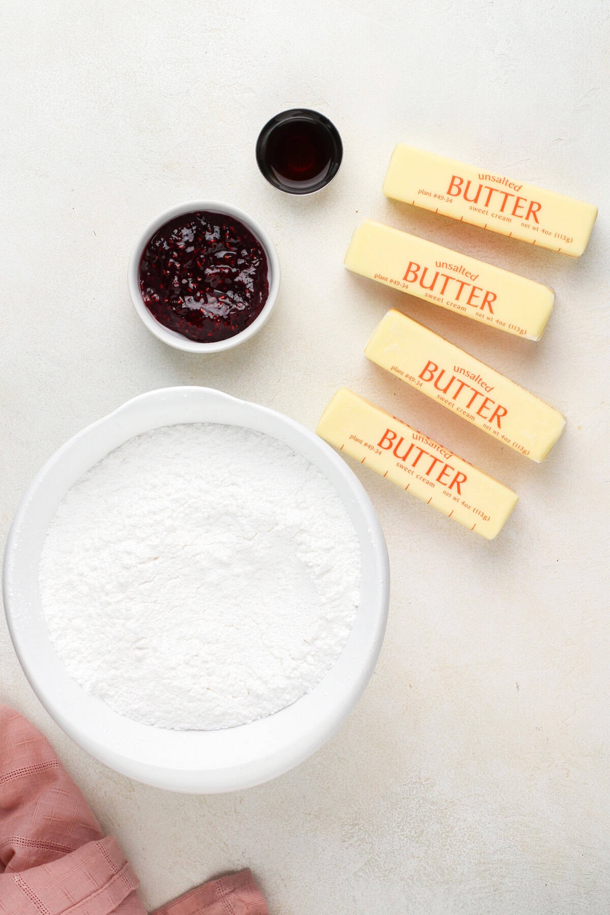 Raspberry buttercream frosting ingredients arranged on a countertop.