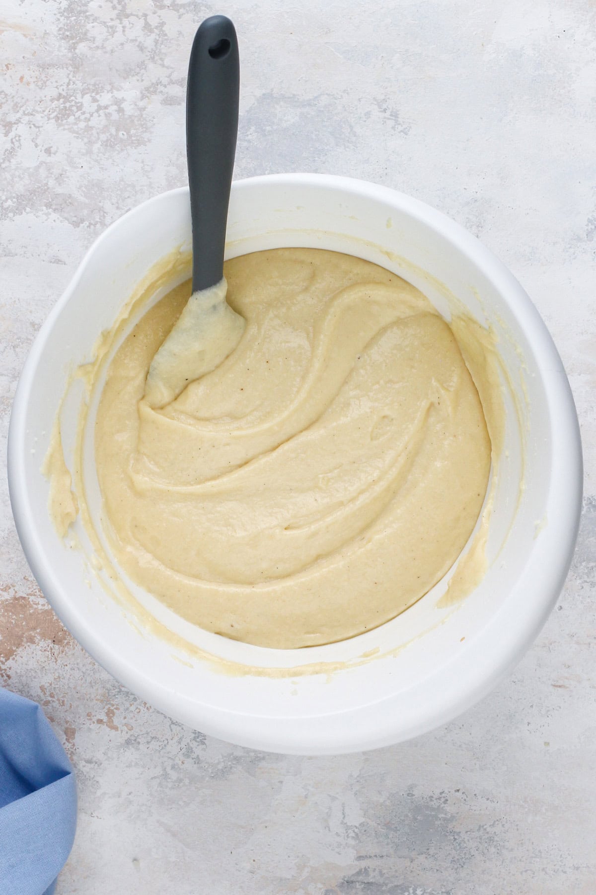 Vanilla cake batter mixed together in a white bowl.