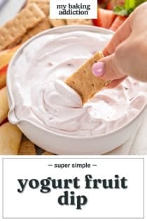 Hand dipping a graham cracker into yogurt fruit dip. Text overlay includes recipe name.