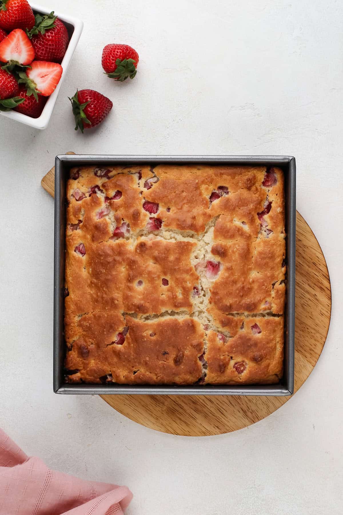 Baked strawberry biscuits cooling in a pan.