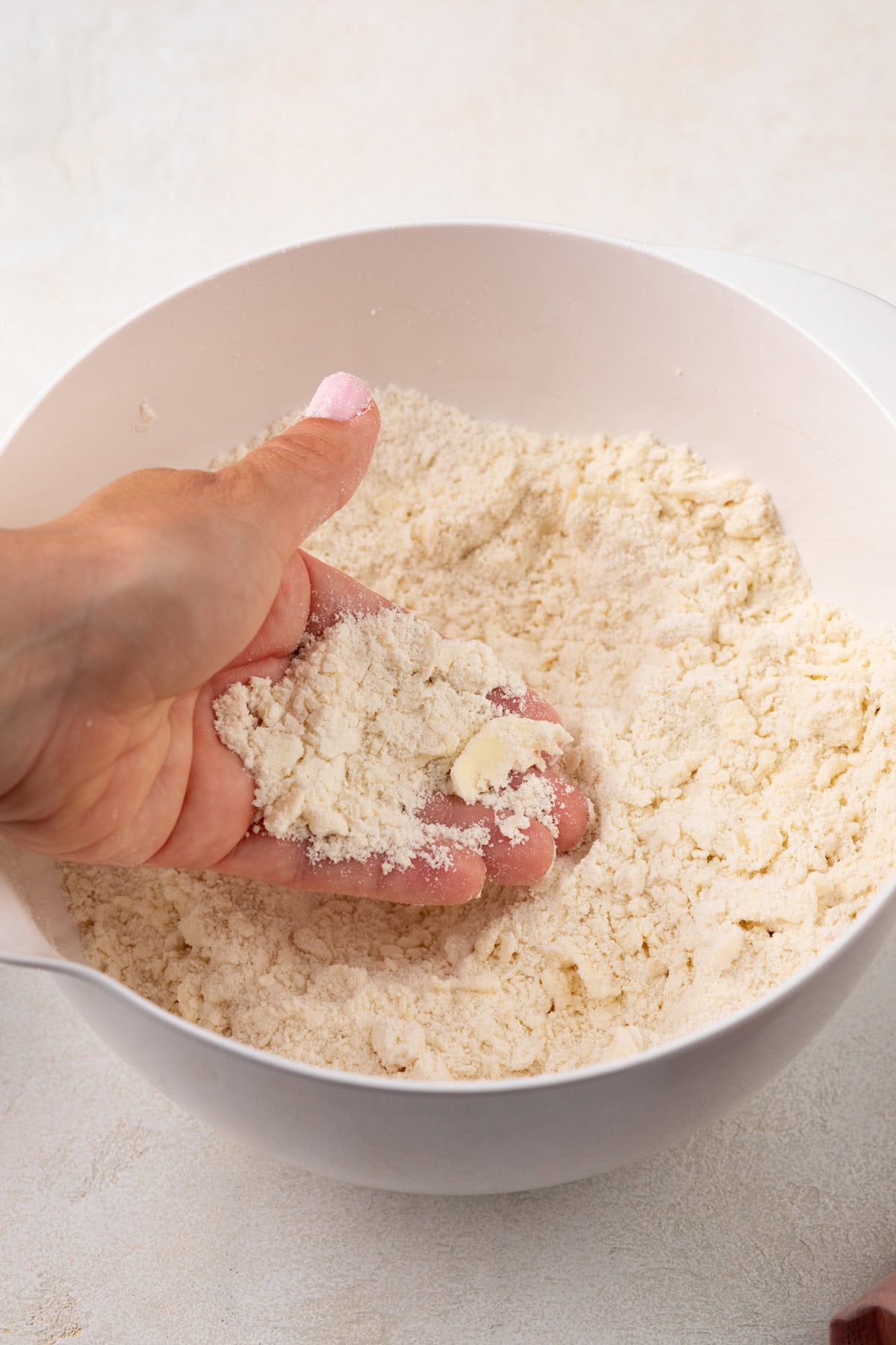 Butter worked into dry ingredients for strawberry biscuits.