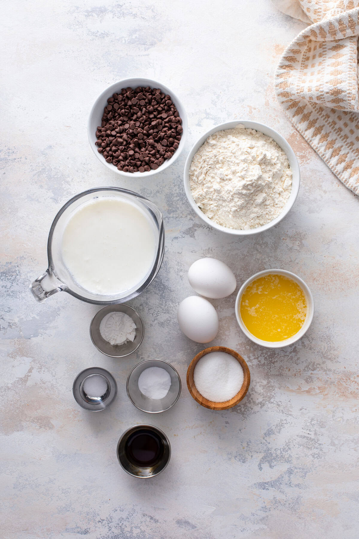 Chocolate chip pancake ingredients arranged on a countertop.
