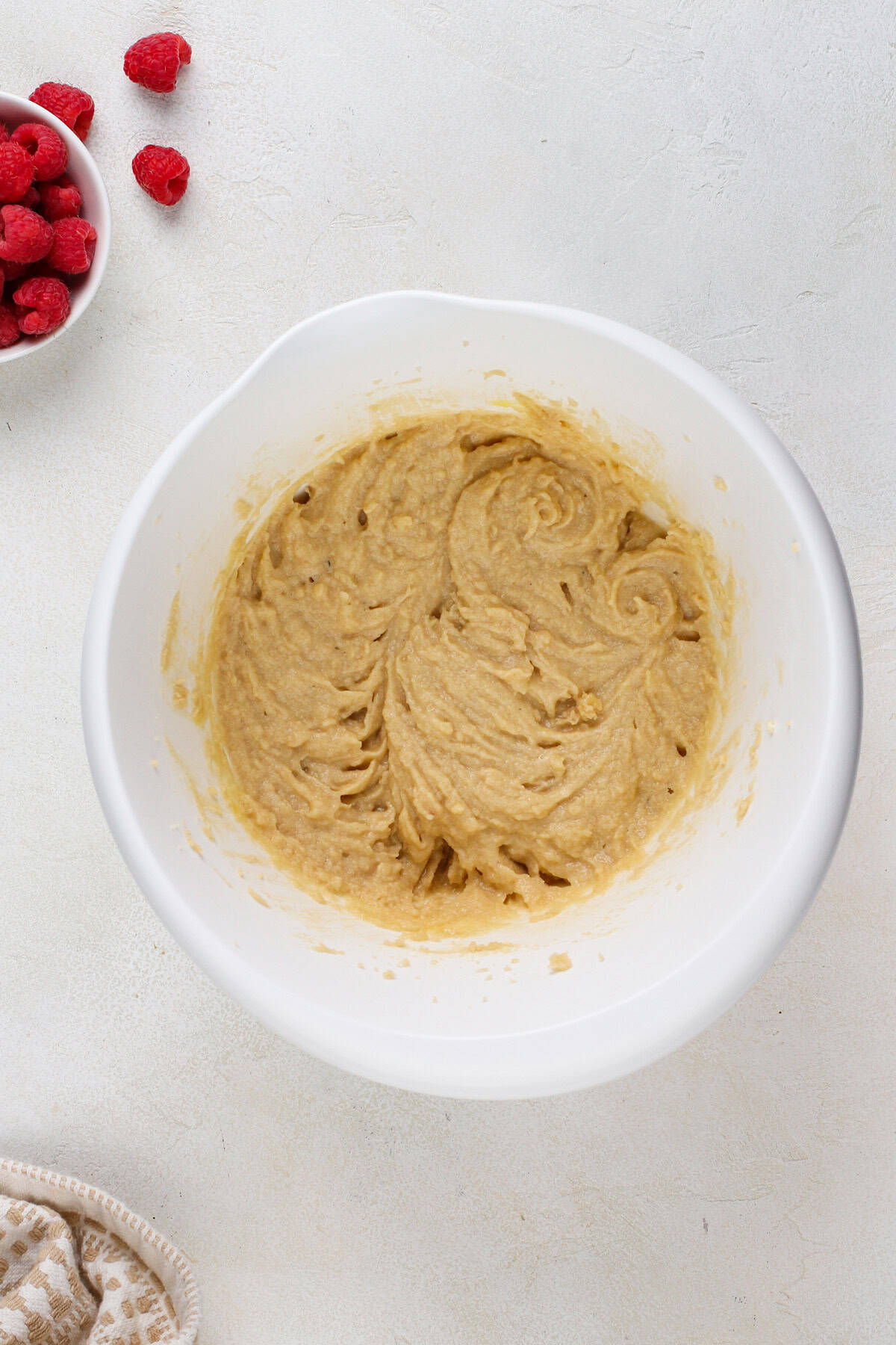 Wet ingredients for cookies mixed in a white bowl.