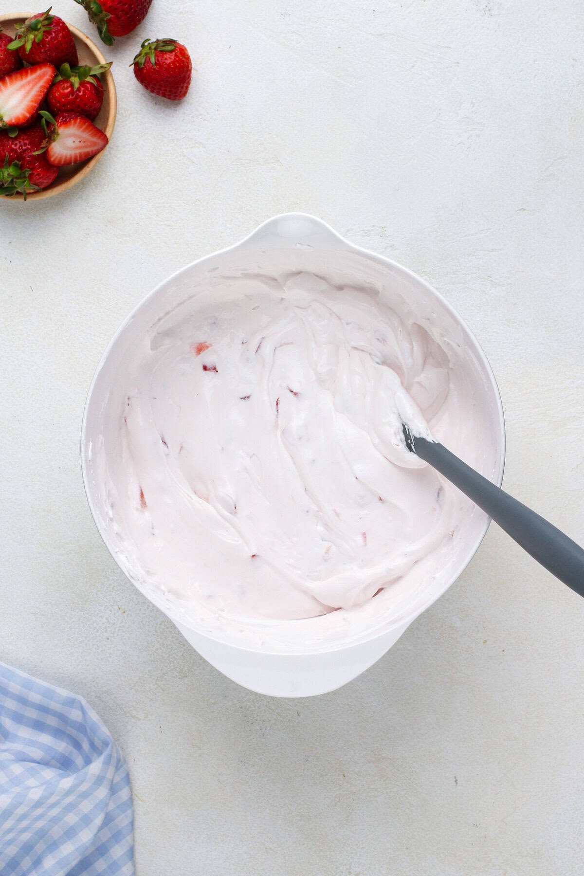 Diced strawberries folded into yogurt fruit dip.