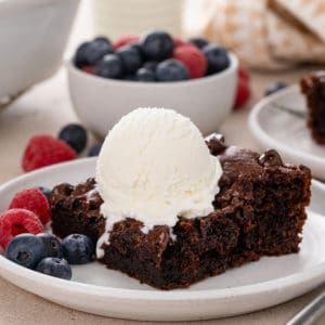 Slice of chocolate dump cake on a white plate.