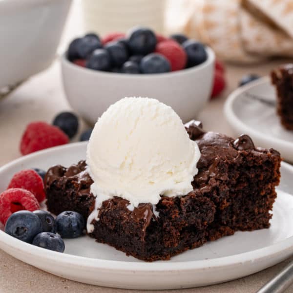 Slice of chocolate dump cake on a white plate.