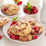 White plate filled with white chocolate raspberry cookies.