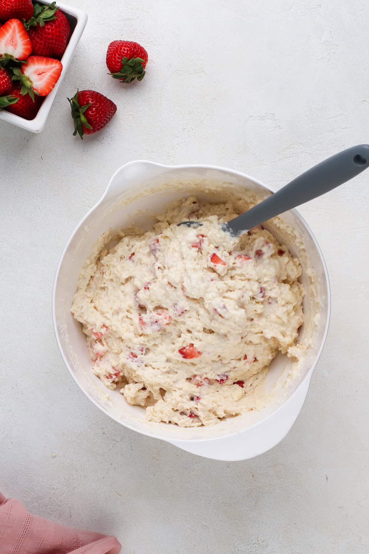 Strawberry biscuit dough in a white bowl.