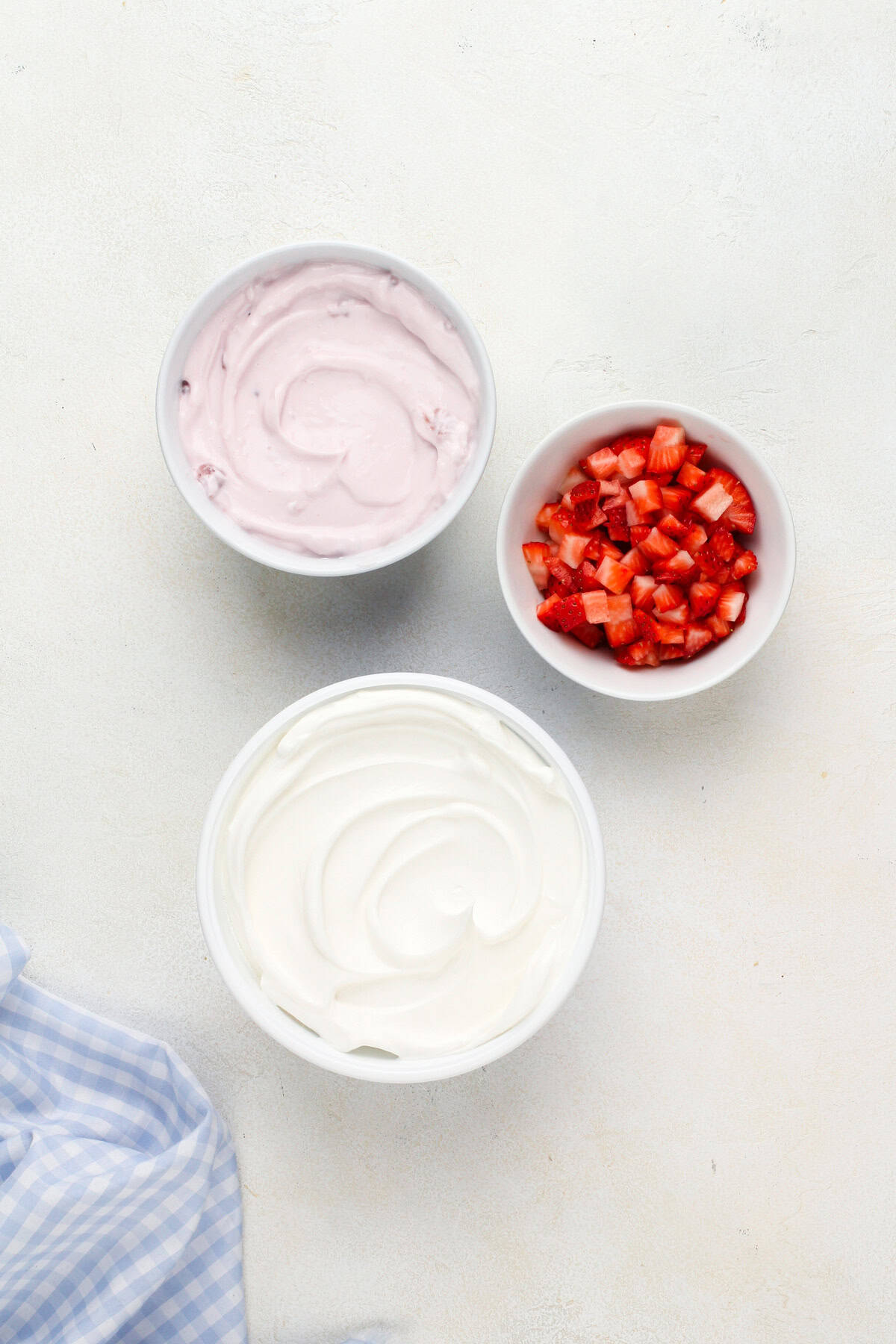 Ingredients for yogurt fruit dip arranged on a countertop.