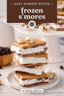 Four frozen s'mores stacked on a white plate. text overlay includes recipe name.