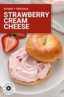 Close up of a bagel spread with strawberry cream cheese on a white plate. Text overlay includes recipe name.