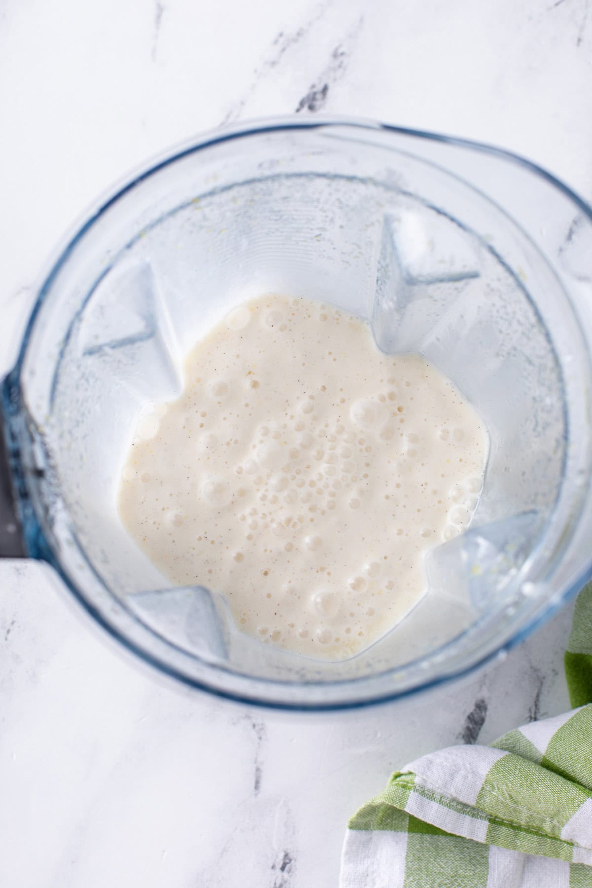 Freshly blended frosted lemonade in a blender.