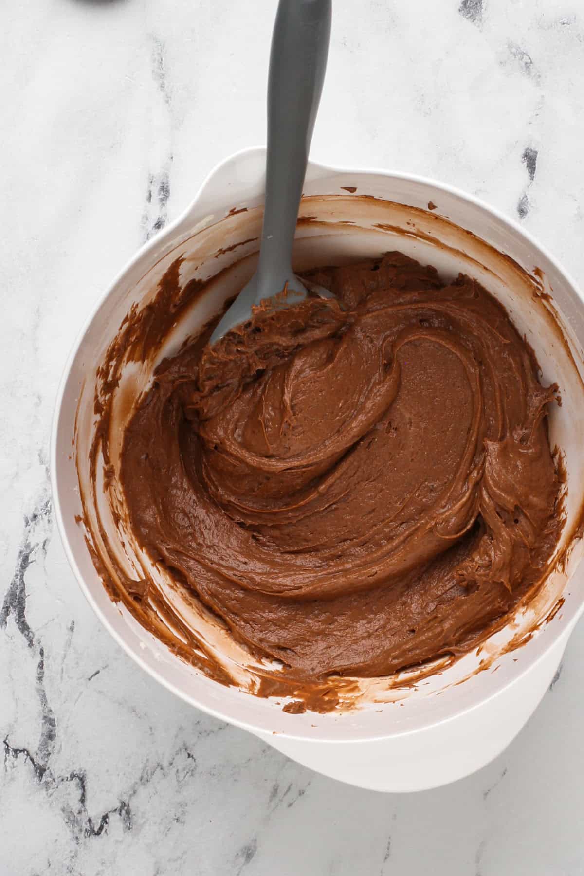 Chocolate pudding and cream cheese mixture in a white bowl.