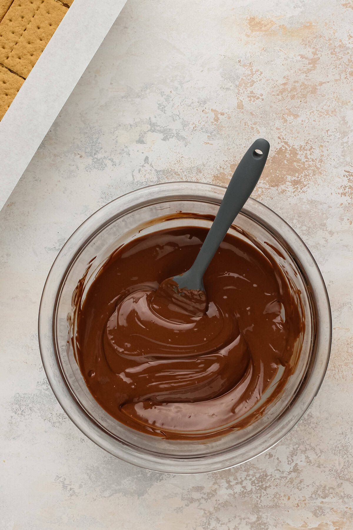 Melted chocolate in a glass bowl.