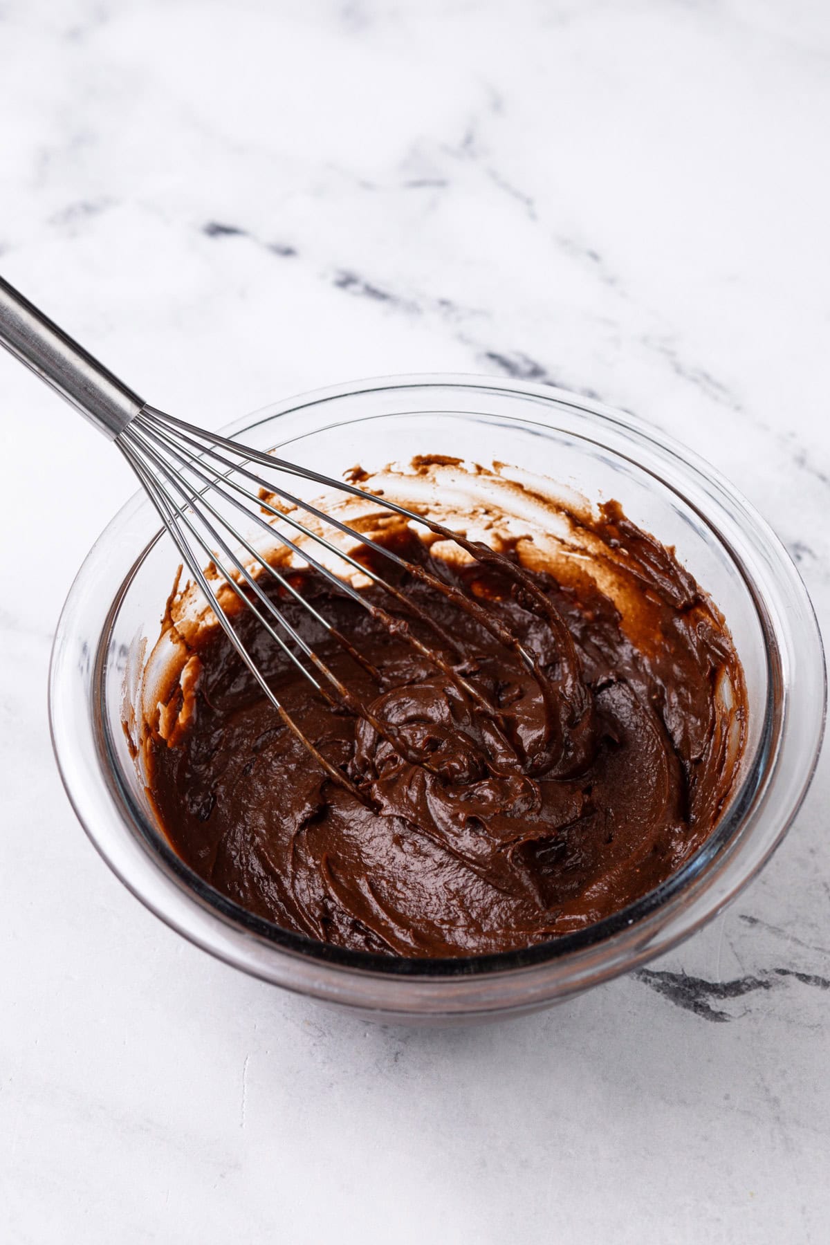 Chocolate pudding whisked in a glass bowl.