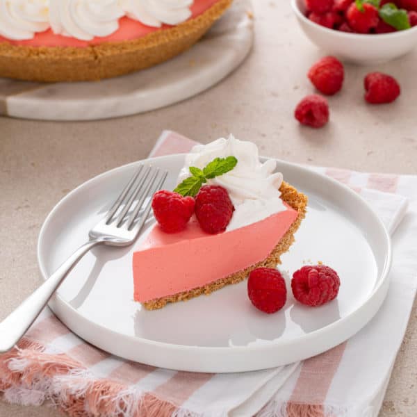 Slice of jello pie on a white plate.