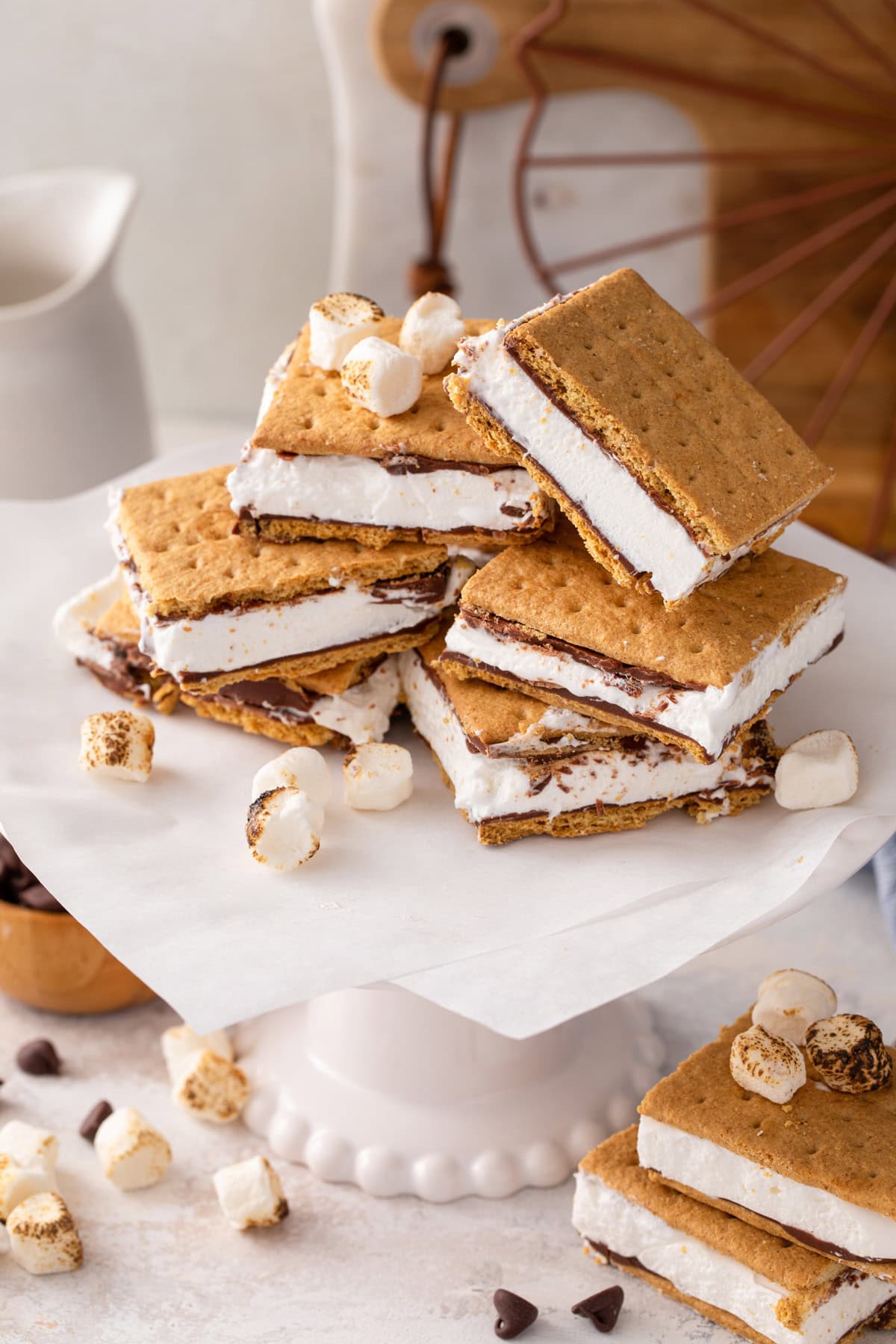 Several frozen s'mores arranged on a cake plate.