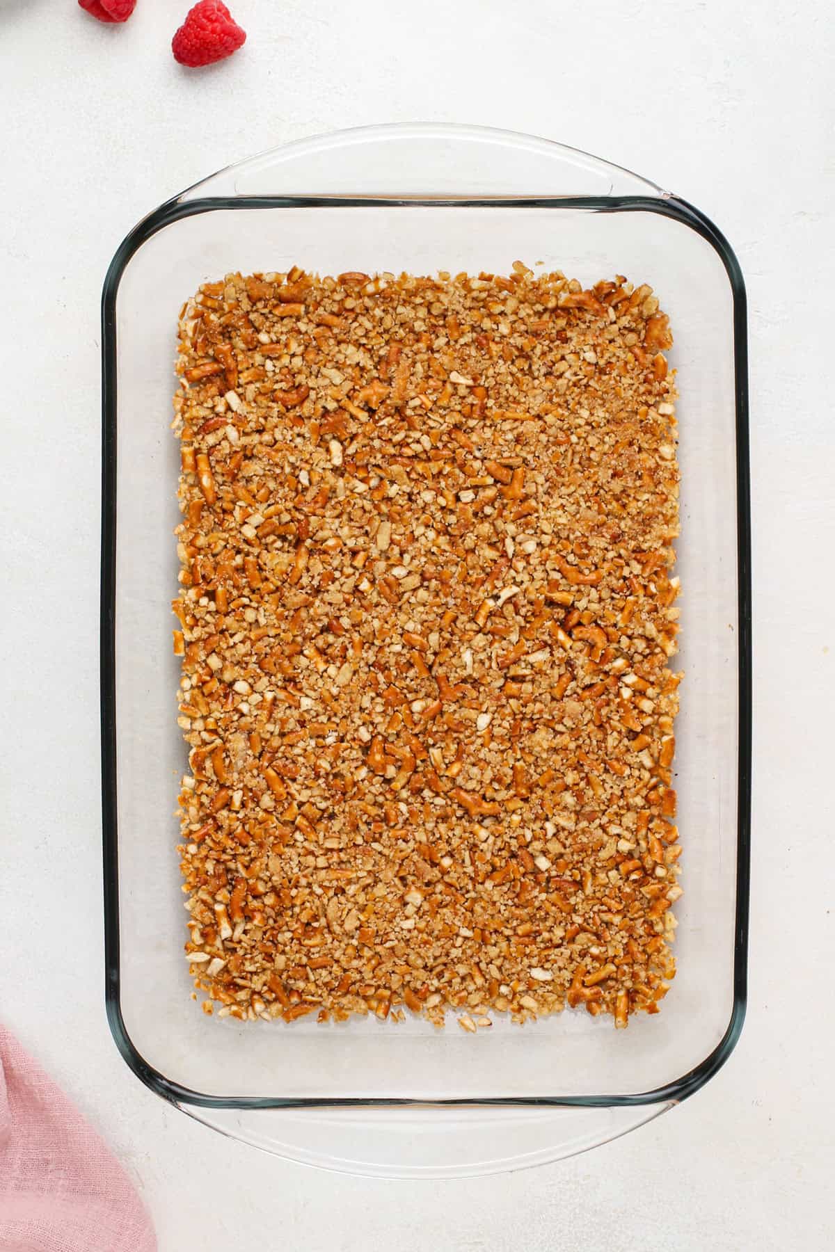 Pretzel crust in a baking dish.