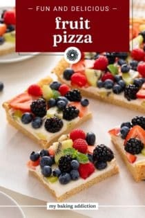 Sliced fruit pizza arranged on a sheet of parchment paper. Text overlay includes recipe name.