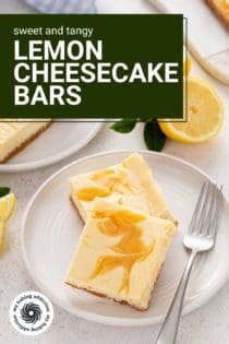 Two white plates, each holding two lemon cheesecake bars. Text overlay includes recipe name.