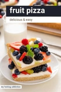 Two slices of fruit pizza stacked on a white plate. Text overlay includes recipe name.