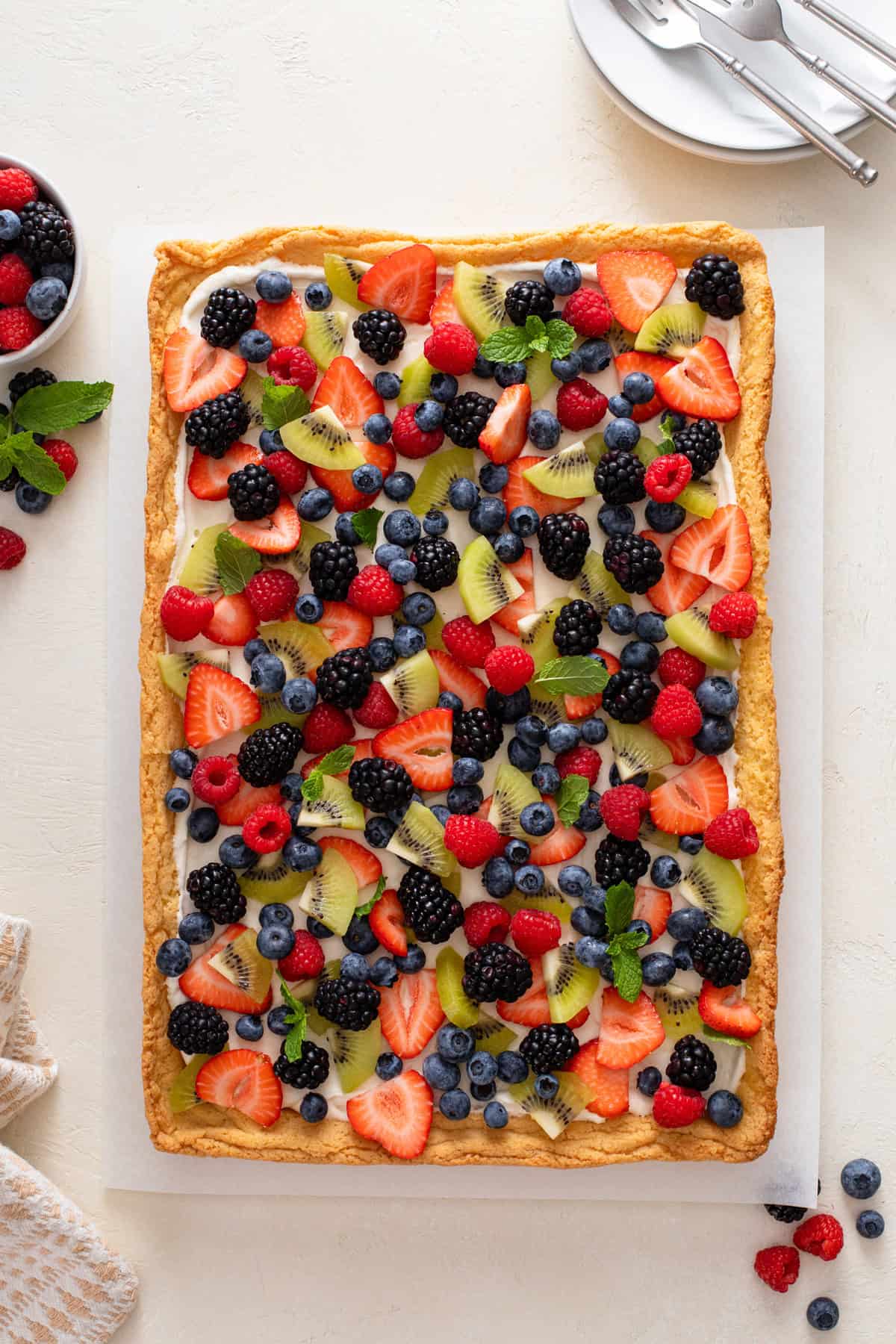 Overhead view of assembled fruit pizza.