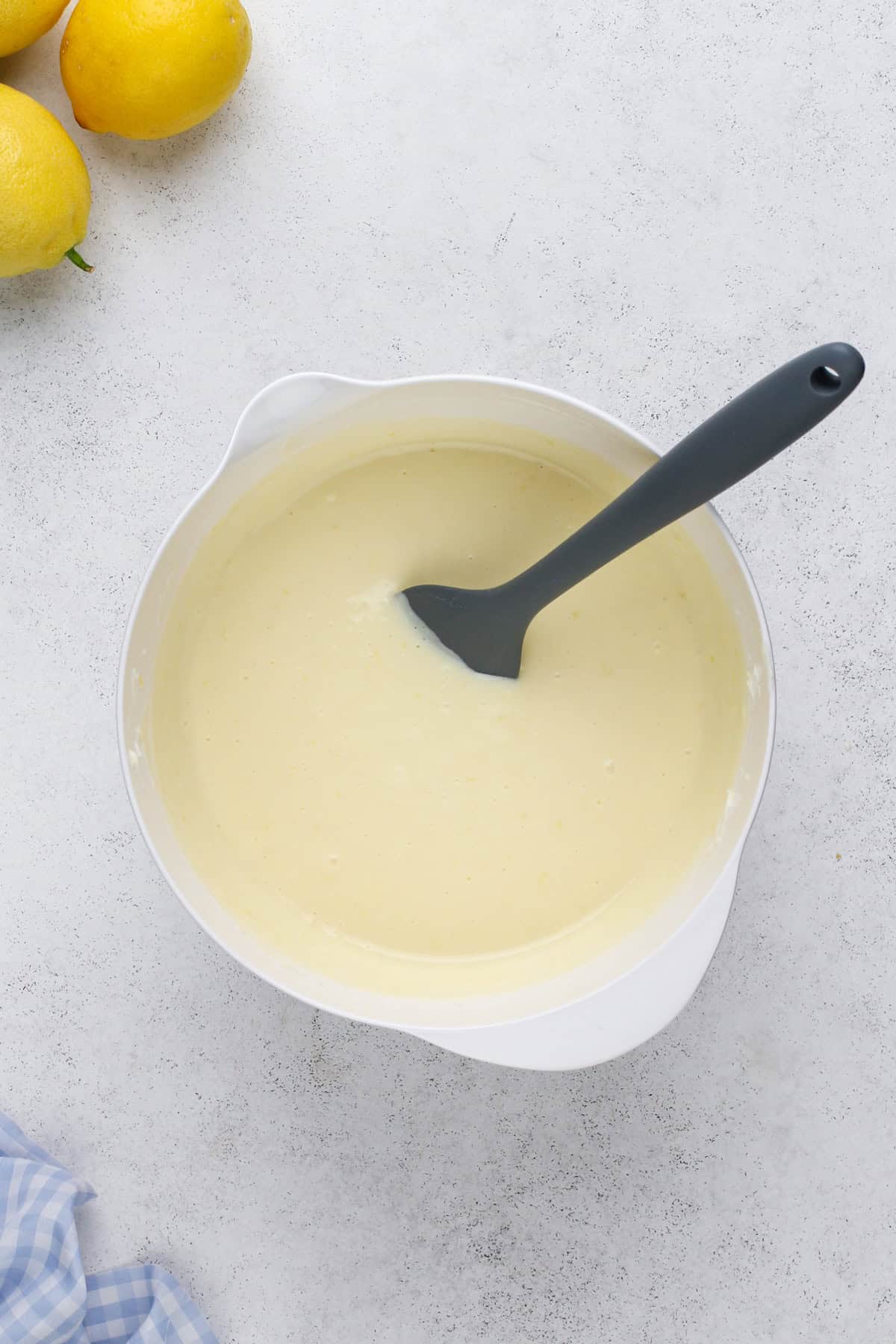 Lemon cheesecake bar batter in a white bowl.