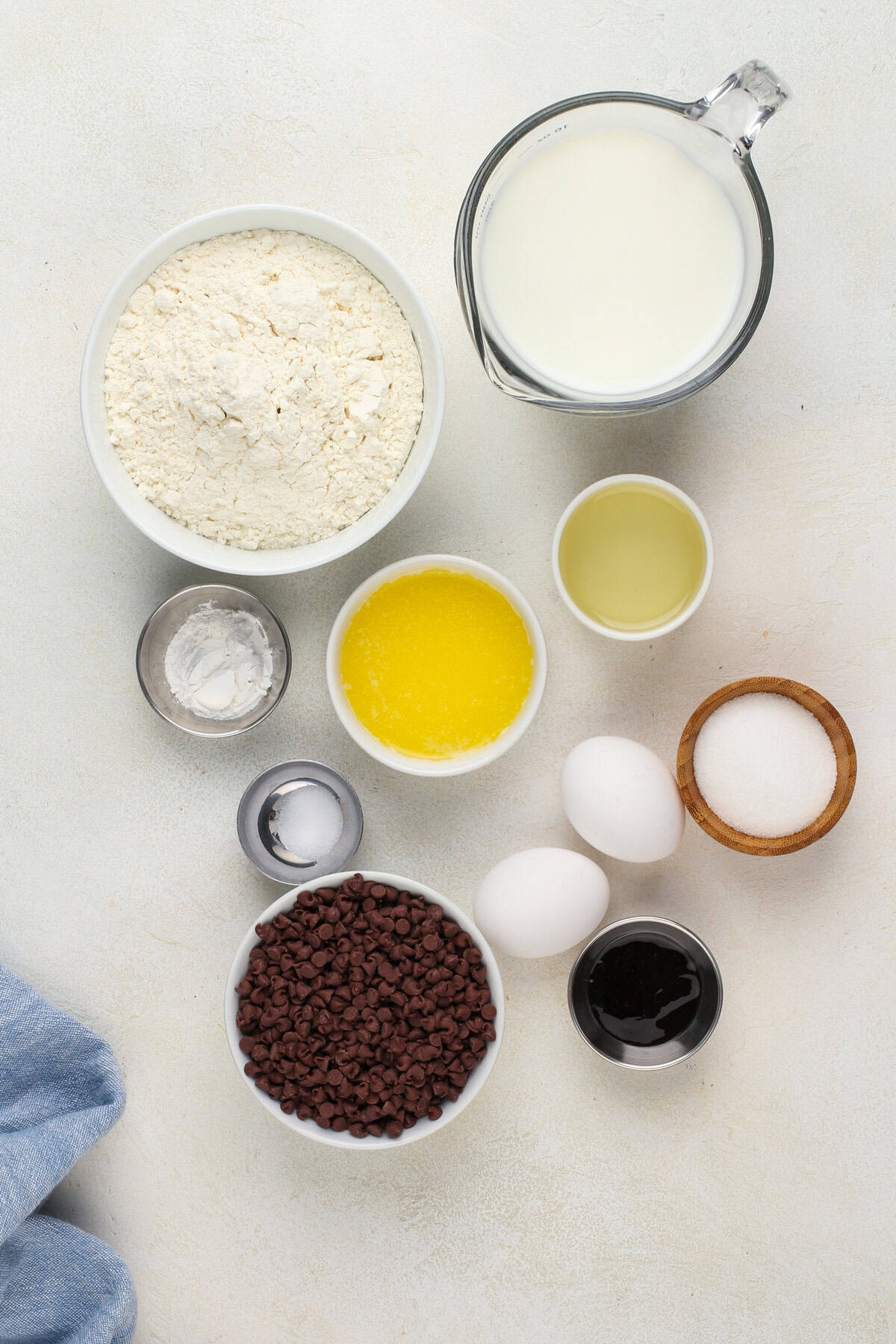 Chocolate chip waffle ingredients arranged on a countertop.
