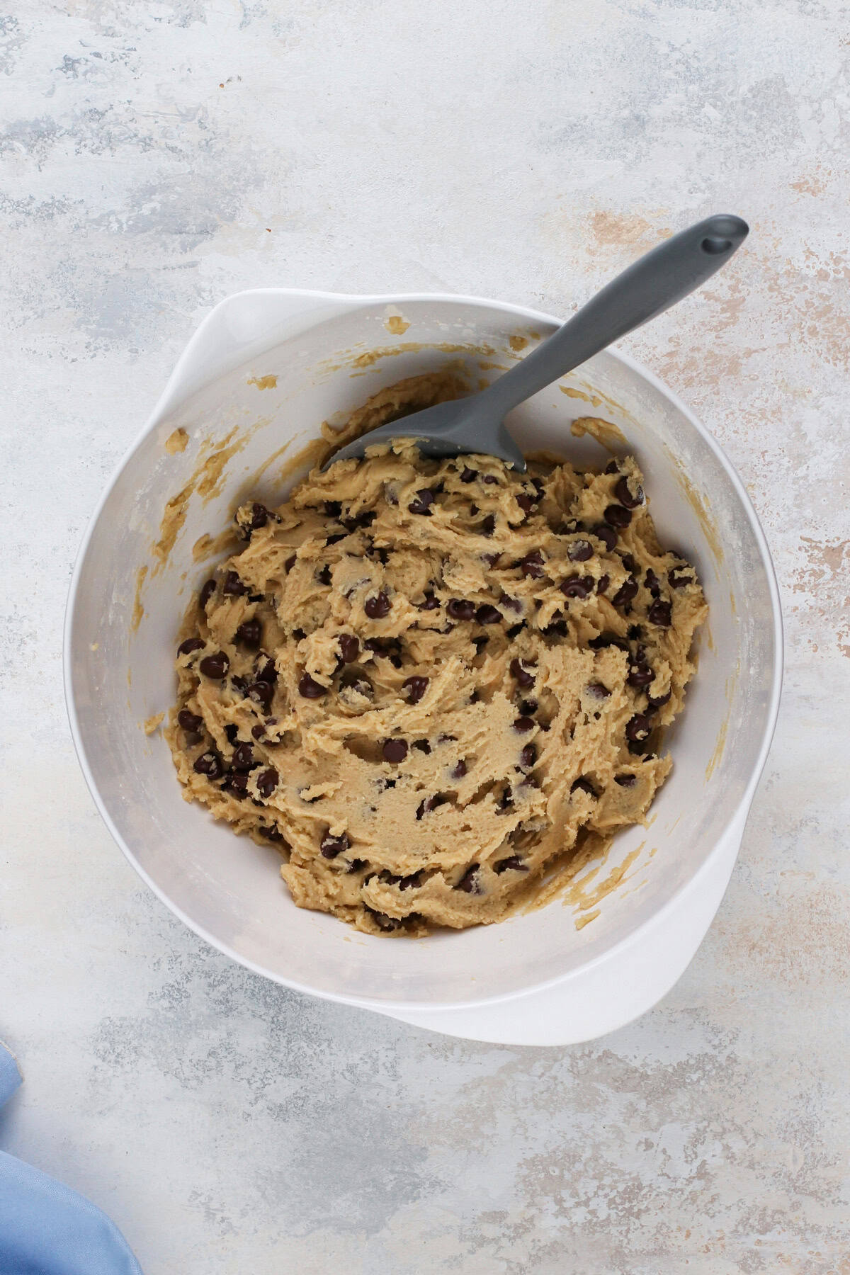 Cookie dough for cookie cake in a white bowl.