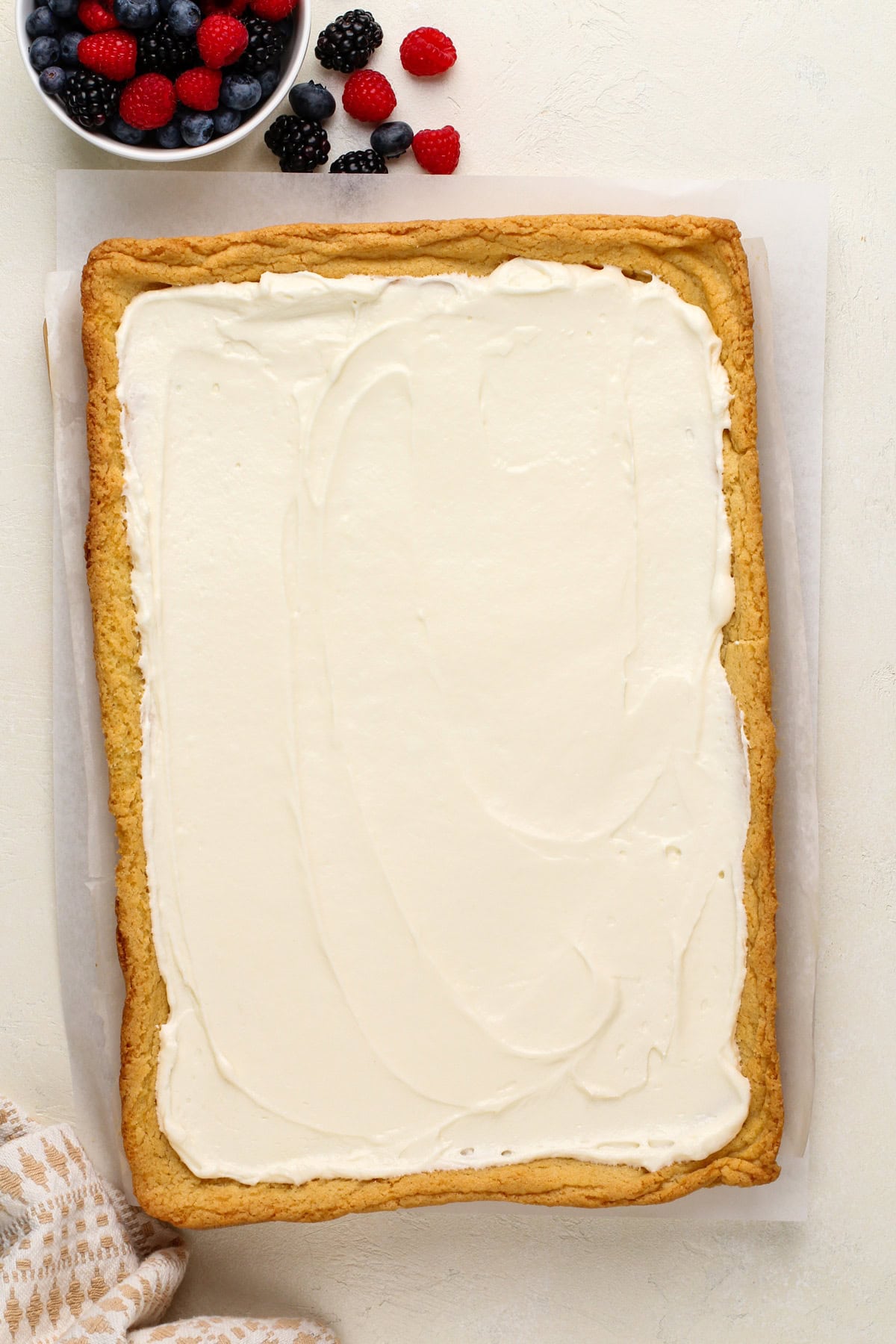 Cream cheese filling for fruit pizza spread over a cookie crust.
