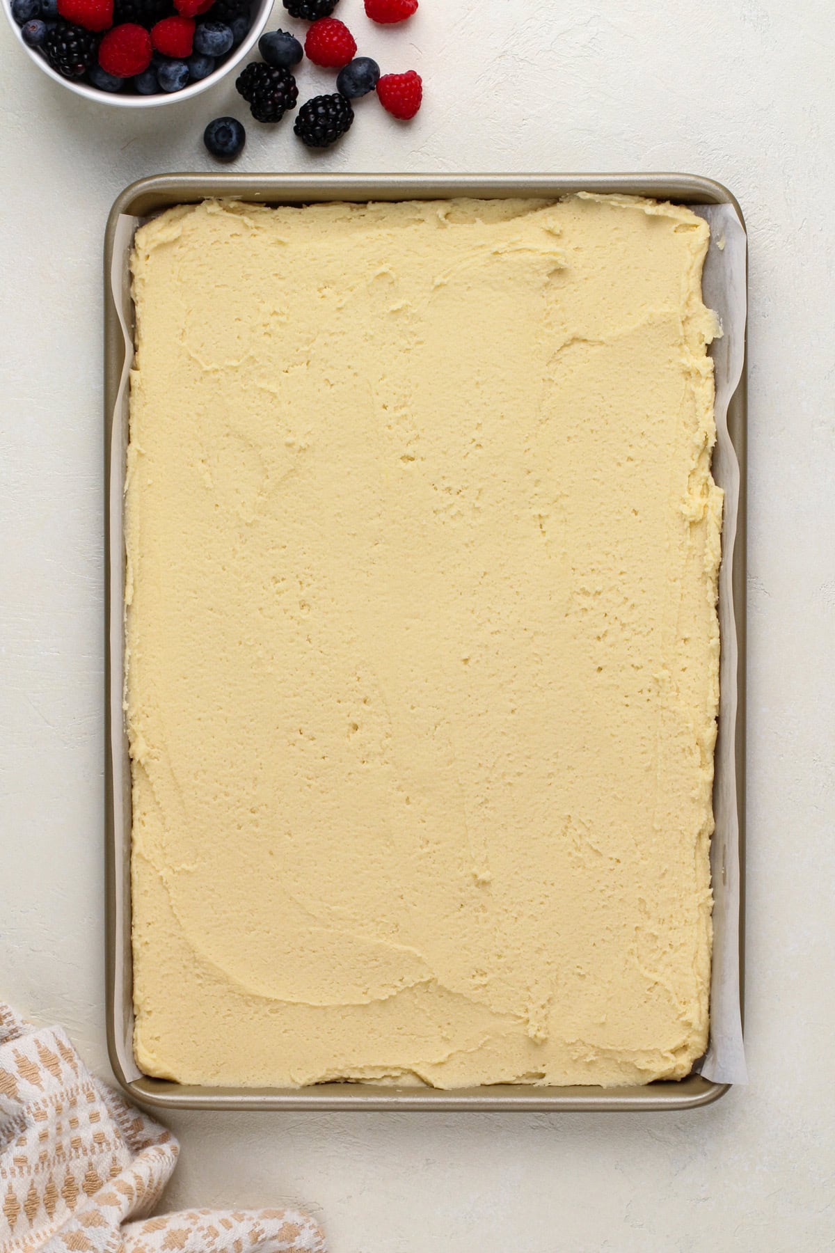 Sugar cookie dough pressed into a jelly roll pan.