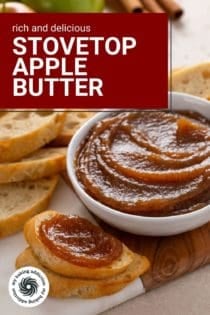 Slice of bread topped with apple butter set next to a bowl of apple butter on a wooden board. Text overlay includes recipe name.