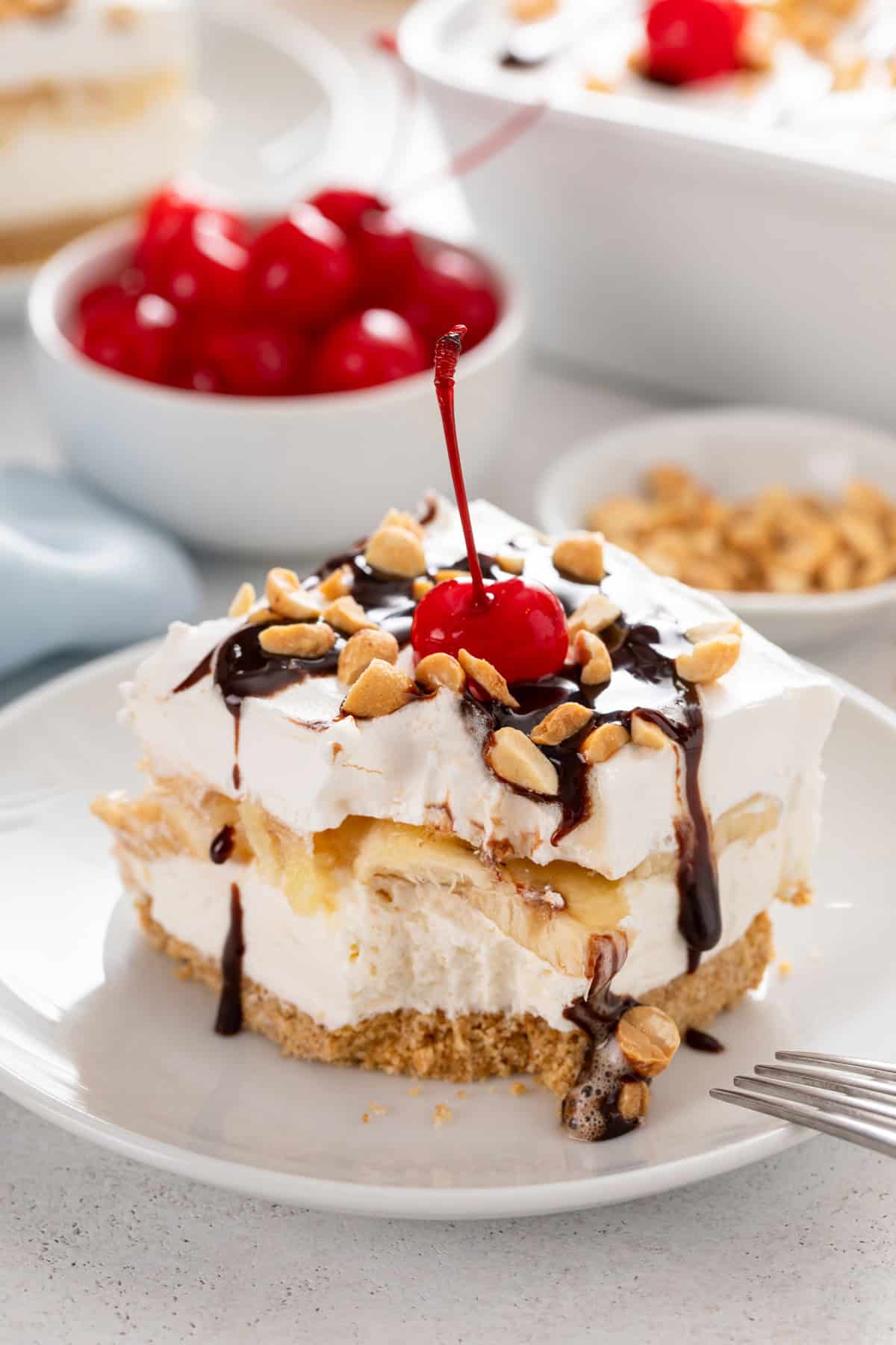 Bite taken from a corner of a slice of banana split cake.