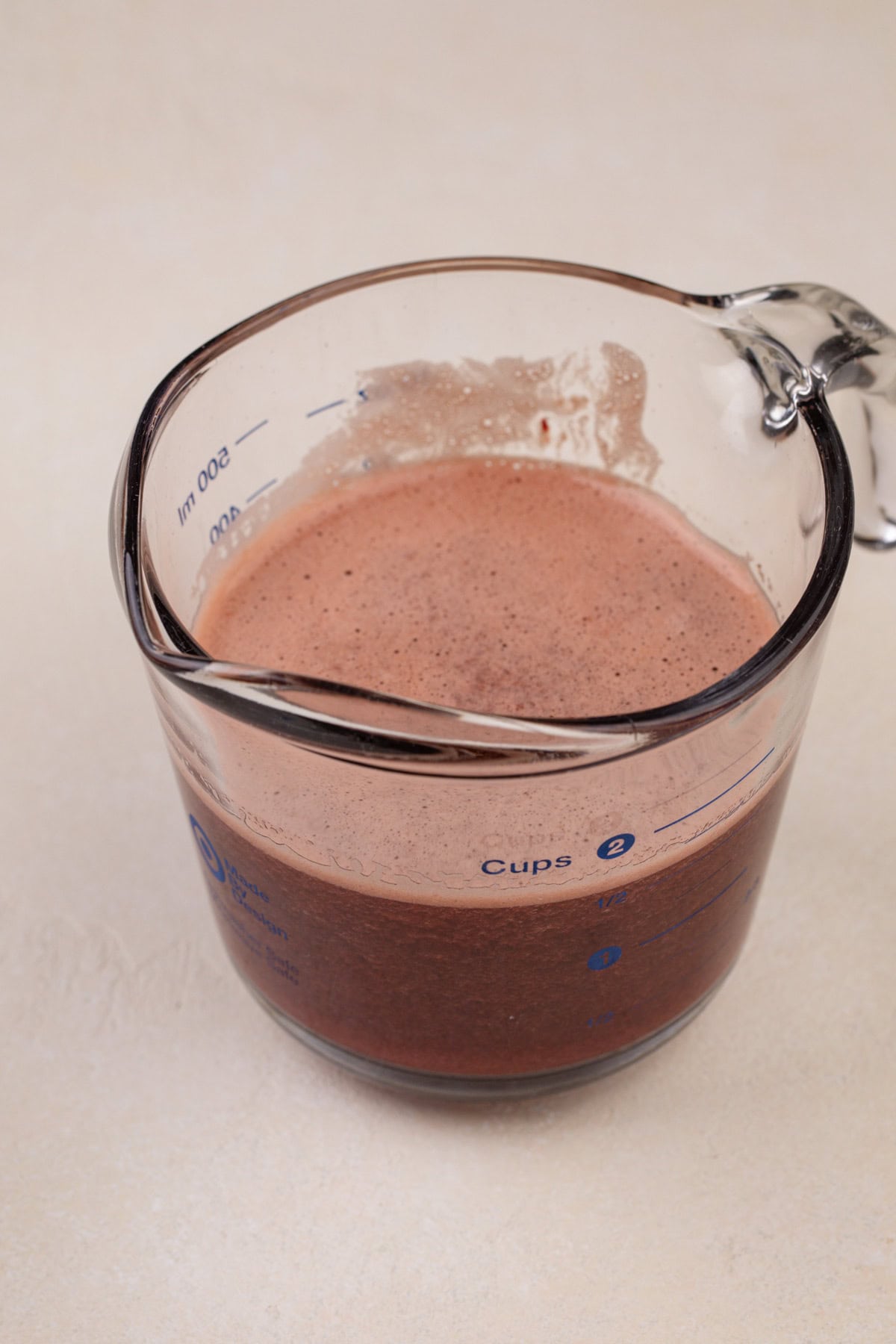 Cherry juice in a glass measuring cup.