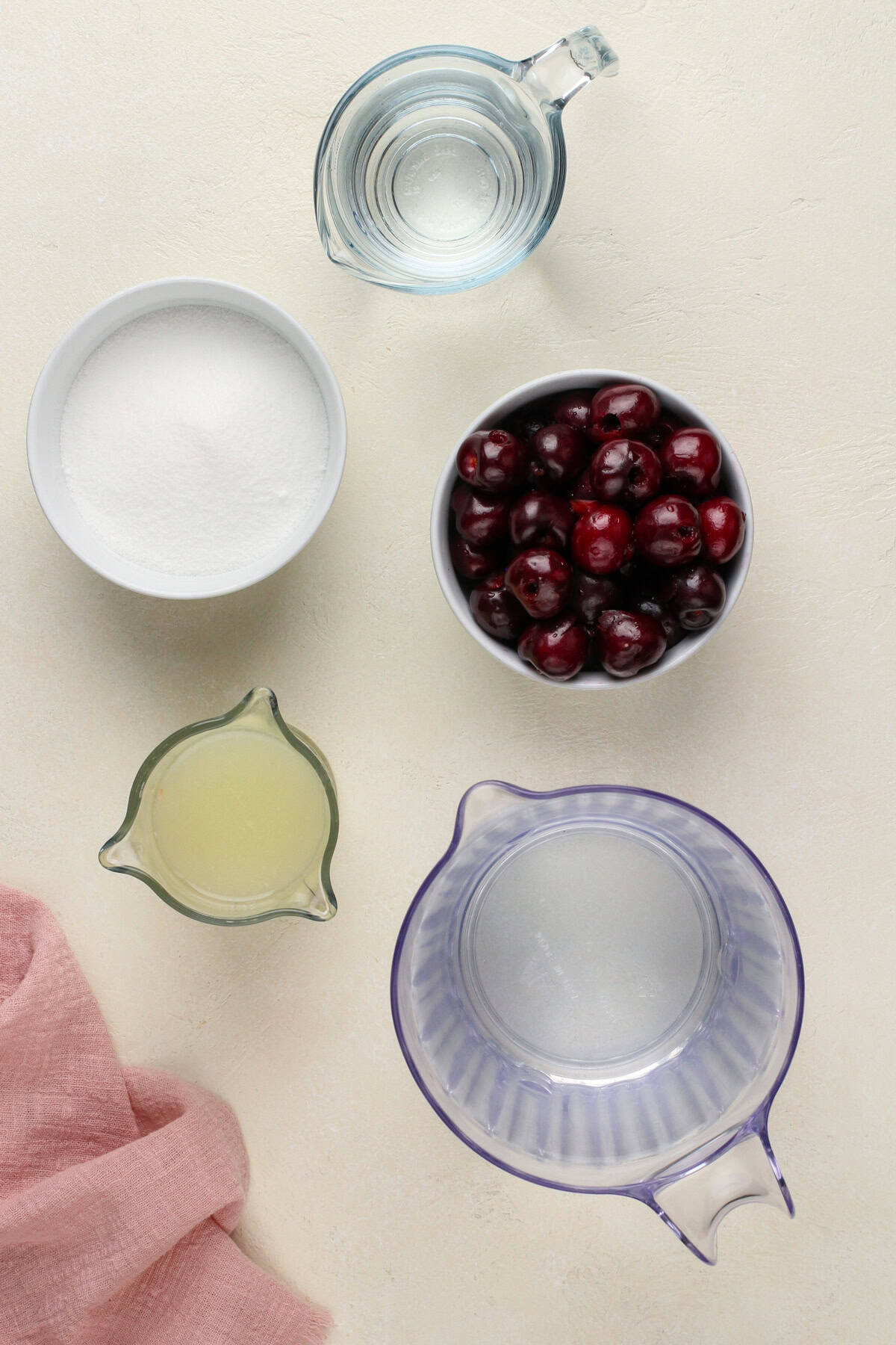 Ingredients for cherry limeade arranged on a countertop.