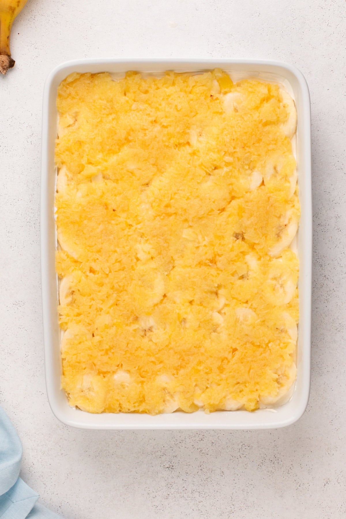 Bananas and crushed pineapple layered into banana split cake.